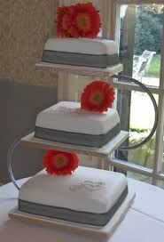 A laconic white square wedding cake decorated with a branch of white blooms is a stylish idea for a minimalist wedding. 3 Tier Square Wedding Cake Stand