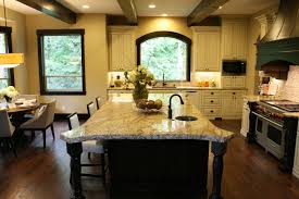 Going into 2021, wood stained kitchen cabinets will still be popular in more traditional kitchens. Pretty Mullican Flooring In Kitchen Traditional With Antique White Kitchen Next To White And Wood Kitchen Alongside Island Post And Island Range Hood
