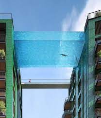 A swimming pool for kids might include a slide and a wading area. London S New Sky Pool Will Let You Live Out Your Flying Fish Fantasies Sky Pool Glass Pool Cool Pools