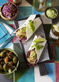 Spoon 3 ounces fish, 1/4 cup salsa, 1 1/2 tablespoons crema, and 1/4 cup cabbage onto each tortilla; Soft Fish Tacos With Tomatillo And Avocado Salsa And Red Cabbage Salad Dish Magazine