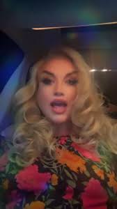 Drag Queen in Blonde Wig Telling Story