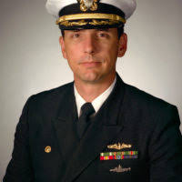 US Navy (USN) Captain (CAPT) Jim Symonds, Commanding Officer (CO), of the  Nimitz Class Aircraft Carrier USS RONALD REAGAN (CVN 76), presents the  Honorable Paul D. Wolfowitz, Deputy Secretary of Defense (DEPSECDEF),