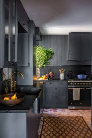 Sleek and modern, this kitchen has black cabinets and a fabulous stainless steel island countertop. How Black Became The Kitchen S It Color Architectural Digest
