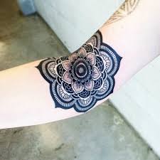 This flower is in a circular design and. Arm Mandala Tattoo Idea