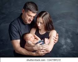 Image of happy couple holding a baby