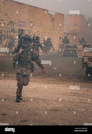 Officer cadets from the Royal Military Academy Sandhurst conduct an assault  during Dynamic Victory 24-01 at the Joint Multinational Readiness Center  (JMRC) near Hohenfels, Germany, March 27, 2024. Dynamic Victory is the