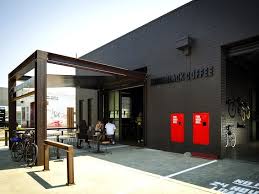 Code Black Coffee Two Melbourne Warehouses Merge To Create Industrial Chic Cafe And Roastery Black Building Architecture Warehouses Exterior