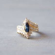 Engagement Ring Trends Throughout The Decades Trending Engagement Rings Vintage Sapphire Ring Ring Trends