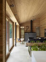 Instead they've been left covered in plywood, which adds to the minimalist feel of this structure. Ultra Modern Cabin Blends Rustic Warmth With Modern Minimalism Cabin Interior Design Modern Cabin Modern Cabin Interior