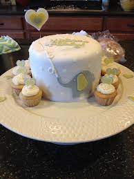Gender Neutral Baby Shower Cake Yellow And Grey With And Elephant Holding A Balloon Shower Cakes Baby Shower Cakes Neutral Elephant Baby Shower Cake