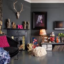 This bohemian living room with slightly open floor plan and clean white walls with a distinctive gallery has a bold and fashionable appearance. Bohemian Living Room Ideas