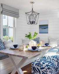 A pair of original abstract artwork in blue and white adorn the space. 7 Coastal Breakfast Nooks For Cozy Quick Meals