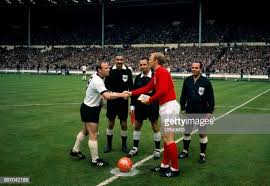 Late in the afternoon of saturday 30th july 1966 the captain of the english football team bobby moore took the jules rimet trophy from the queen of england and lifted it above his head, acknowledging the acclaim of a. Captain Uwe Seeler Of West Germany Shakes Hands With Captain Bobby England Football Germany National Football Team World Cup