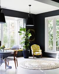 A black range, fume hood, and hardware creates contrast against light cabinetry and walls in this bright tribeca kitchen. 28 Ideas For Black Wall Interiors How To Style Them