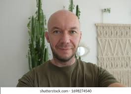 Young Bald Guy Green Shirt Taking Stock Photo 1698274540