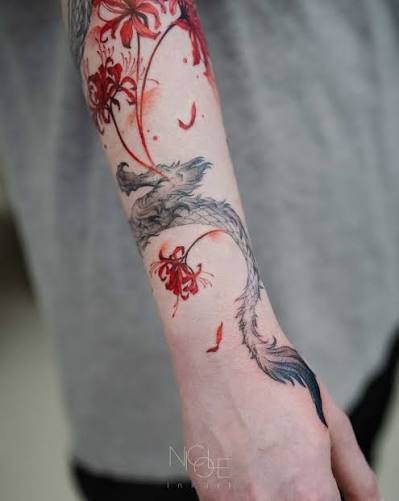 Wrapped in ink and movement— a red spider lily blooms while the dragon coils with power. Fine lines. Soft watercolor. Flow that follows the arm. Would you wear something like this? . . . .