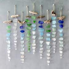 Driftwood and sea glass pieces are glued to a canvas. Sea Glass Suncatcher Free Shipping Single Strand Seaglass Etsy Sea Glass Crafts Glass Crafts Wind Chimes