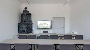 In the centre of the room is an oval table; The Seminar Rooms Science And Study Center Raitenhaslach