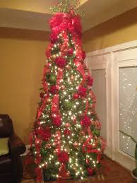 Christmas Tree Using Clear Lights With Red Ribbon Bow As Topper And Ribbon Weaved Dow Christmas Tree Decorating Themes Ribbon On Christmas Tree Tree Topper Bow