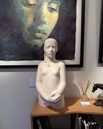 This latest sculpture is by Michael Thacker. British sculptor Michael  Thacker's distinctive, abstract style sculptures are made from local  limestone, and Michael uses 24 carat hand-beaten gold leaf to reflect or  accentuate