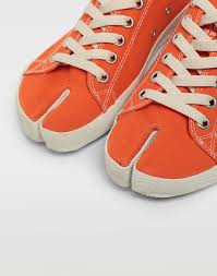 Founded by the unconventional martin margiela, maison margiela is a pioneering label in deconstructionist design. Maison Margiela Tabi Low Top Canvas Sneakers In Orange Lyst