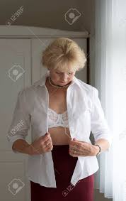 Maybe you would like to learn more about one of these? Elderly Woman Getting Dressed Putting On A White Shirt Stock Photo Picture And Royalty Free Image Image 42381882
