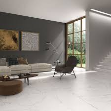 Go all out with stark white, or mix and match shades of white for more of a cozy approach. White Tile Floor Living Room Living Room Tiles Tile Floor Living Room Living Room White