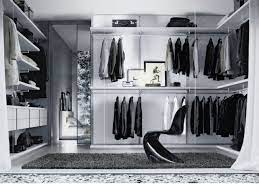 Custom black cabinetry and a vanity with white counter were built into the angled walls. A Glamorous Black And White Dressing Room