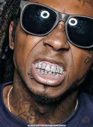 Have you seen the itsy bitsy teeny weeny diamonds on his teeth? Tunechi Glasses Tattoo Lil Wayne Grillz