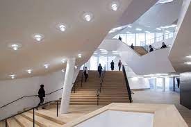 A star pendant light casts beautiful shadows in the evening and a mercury glass lamp adds a soft glow. Image 3 Author Iwan Baan Elbphilharmonie Foyer Cut Guiding Architects