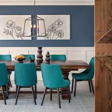 Closeup image of baked turkey on family festive dinner table against burning fireplace. 15 Modern Dining Room Ideas