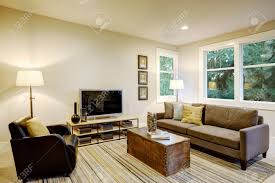 Covered with premium faux leather, this storage chest is super easy to wipe clean with damp cloth. Family Room Interior With Gray Sofa Facing A Black Leather Armchair Across From A Trunk Coffee Table Atop A Gray And Brown Striped Rug Northwest Usa Stock Photo Picture And Royalty Free