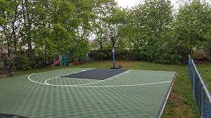 Consider additional netting or fencing once your court is complete to keep from chasing the ball. Modutile Green And Black Outdoor Basketball Court Facebook