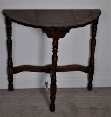 The distressed natural brown finish shows off the wood's unique grain color variation. Vintage Half Moon Wooden Table