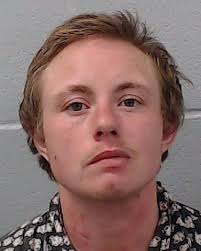 English, James Avery was booked into the Hays County Jail