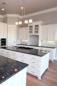 White Cabinets Mosaic Stone Backsplash Blue Pearl Granite Countertop Hardwood Floor In 2020 Kitchen Design Countertops Granite Kitchen Kitchen Countertops