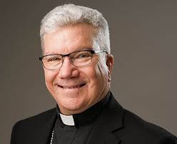 LA priest surprises mom and infant arriving