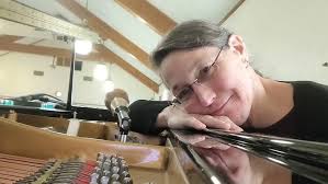 Brigham Introduces our polished Ebony Pearl River Upright Piano