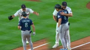 Payton Tolle hugs Dominic Canzone while tagging him out during Mariners Red Sox game
