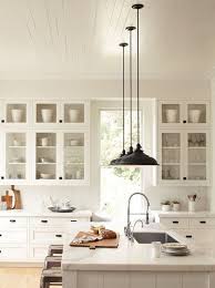 Light porcelain flooring, white ceramic tile backsplash, under cabinet task lights, chrome industrial pendant lights and stainless steel appliances features a modern kitchen design. Shaker Style Lighting Ideas On Foter