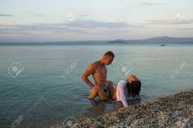 Summer Holidays And Paradise Travel Vacation. Love Relations Of Naked  Couple In Sea Water. Couple In