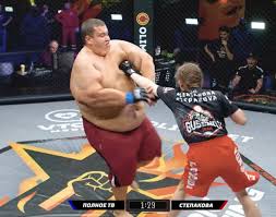 Female strawweight star fights enrmous male heavyweight in mismatch MMA bout