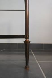 Antique bronze • handcrafted with care using premium solid metal • features large round shape with removable top that reveals plenty of storage • multipurpose table can be used as coffee or cocktail table; Solid Brass Glass 2 Tier Coffee Table 1960s For Sale At Pamono