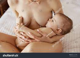 Стоковая фотография 657764986: Young Beautiful Naked Mom Breastfeeding  Hugging | Shutterstock