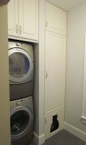My lg washer and dryer are stacked and i have had no problems reaching into my dryer at all. Stacked Washer Dryer Next To Tall Pantry Cabinet With Custom Cat Shaped Door To Littler Box Stacked Laundry Room Compact Laundry Room Laundry Room Closet
