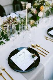 Chic white roses in individual glass vases ran down tablescapes for a fresh and modern look, while the couple's sweetheart lounge made jaws drop. Black White And Gold Wedding Table Setting Emmalovesweddings