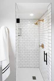 Our shower wall panels are now available in two new solid surface subway tile patterns that take classic to a new level. White Subway Shower Tiles With Gray Grout And Brushed Gold Shower Head Transitional Bathroom