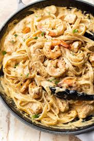 There S Chicken And Shrimp In This Creamy Cheesy Alfredo Pasta With A Cajun Kick Chicken Alfredo Recipes Chicken And Shrimp Recipes Chicken And Shrimp Alfredo