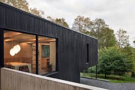 It still adds drama and interest but isn't as deep as other shades. Modern Charred Timber House Juts Out Of Quebec S Forest Landscape