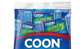 Man smiling, holding a package of coon cheese leaf cookbook. New Snack Range For Coon Cheese And Cracker Barrel Convenience Impulse Retailing